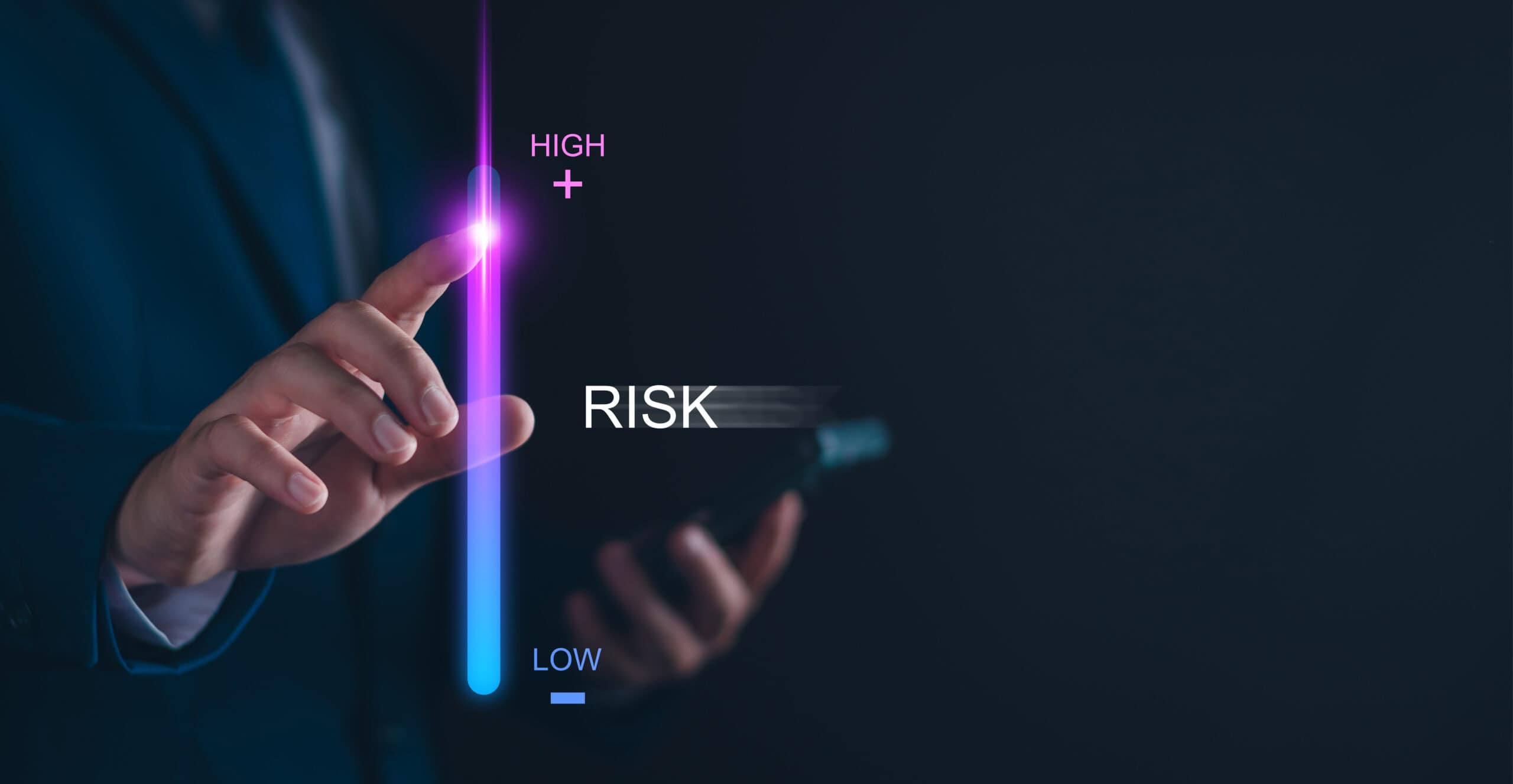 Risk management technology concept with high and low risk indicators and a person's hand interacting with a digital interface.